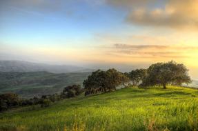 Beautiful landscape with the green mountains of South Andalusia, at colorful sunset in Spain