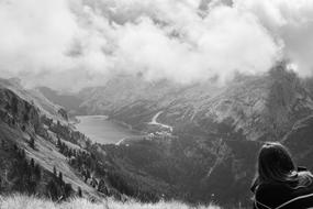 monochrome photo of a girl sitting on a mountain top