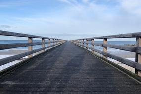 wooden pier with railings on the sea