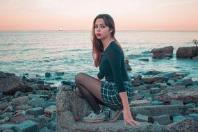 girl on the rocky coast at dusk