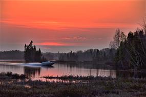 Boat on the lake in Canada in Orange Twilight