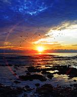 Beautiful water at colorful and bright sunset on horizon