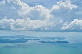 white clouds over blue ocean