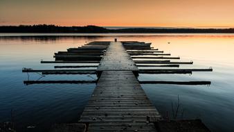 wooden pier on the lake at dusk