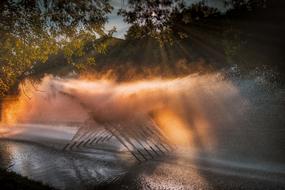 sunset in the spray of the fountain