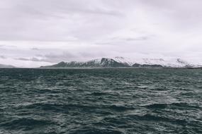 distant view from the water to the snow-capped mountains