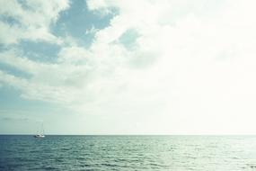 distant view of a sailboat on the sea on a sunny day