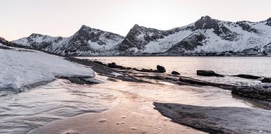 Beautiful landscape with the snowy Devils Teeth in Ersfjord, Norway, in the sea