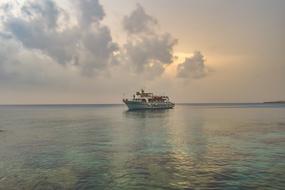 boat at sea under white clouds