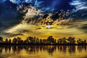 yellow sunset in the clouds reflected in the lake