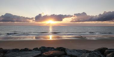 scenic Sunset over empty rocky beach