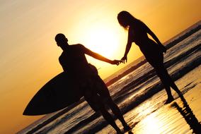 Surfing couple at Sunset Beach