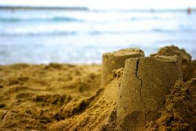 Close-up of the sand castle, on the beach of the sea in sunlight