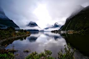 morning fog over mountains and lake in New Zealand