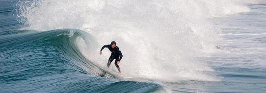 surfer riding a board on the waves