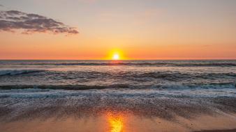 reflection of setting sun on wet beach, Denmark