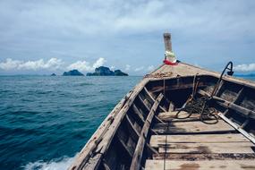 wooden boat sailing to the island