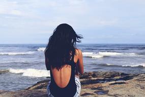 girl sitting on shore