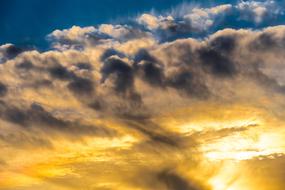 yellow sunset in gray thick clouds