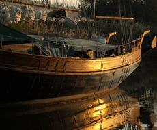 wooden fishing boat with sails