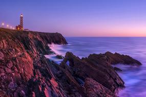 lighthouse on the cliff against the background of the night sky