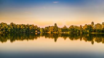 Beautiful landscape of the pond, among the colorful trees, with reflections, at colorful and beautiful