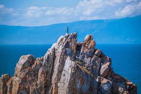 Person standing on the beautiful and colorful mountain in Switzerland, under the blue sky with clouds