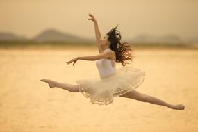 ballerina flies against the background of the sea