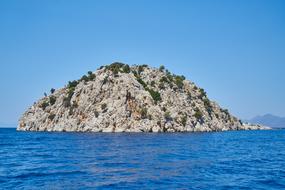 rocky island in the sea on a sunny day