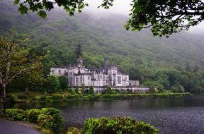 lakeside castle near forest in ireland