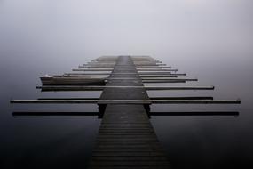 a pier on the sea in the fog in finland