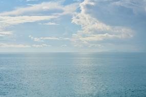 blue sea water and sky with clouds