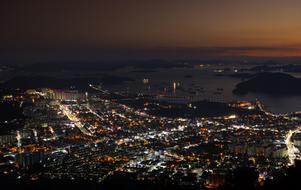 Night view of Jinhae, South Korea, wihth the colorful lights on the coast, at colorful sunset