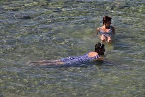 swimming in the clear water of the lake