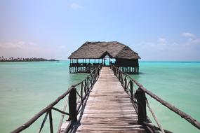 wooden pier over turquoise water in tanzania