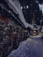 snowy city street at night