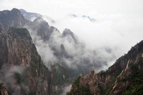 thick white clouds at the top of huangshan, china