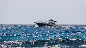 Beautiful and colorful, shiny sea with the boat in motion