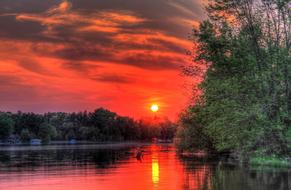 reflection of a colorful sunset in the water in an idyllic landscape