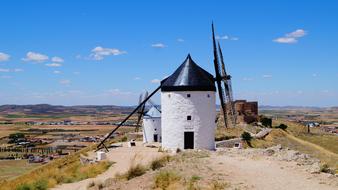 Beautiful landscape with the mill, among the colorful fields in Consuegra, La Mancha, Spain