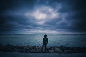 Person Standing Shore in the blue twilight