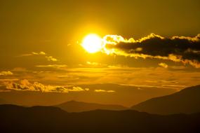 Beautiful landscape with silhouettes of the mountains, at colorful and beautiful sunrise with clouds