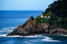 distant view of the lighthouse on the cliff on the picturesque coast