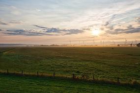 sunrise over green fields