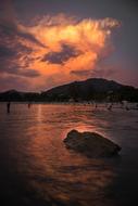 golden cloud in purple sky over lake