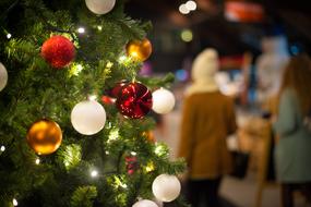 people and balls on the christmas tree