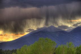 Beautiful landscape of San Francisco Peaks, behind the trees, at colorful and beautiful dusk