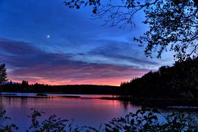 purple sunset over a lake in canada