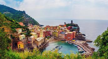 Beautiful landscape of the colorful town on the coast of the mountain, with plants, in Italy