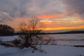 Sunset over frozen lake, scenic Winter Landscape